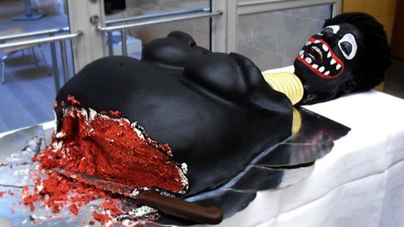 Illustration for article titled Swedish Official Gleefully Cuts Racist Black Lady Cake, Delights Onlookers